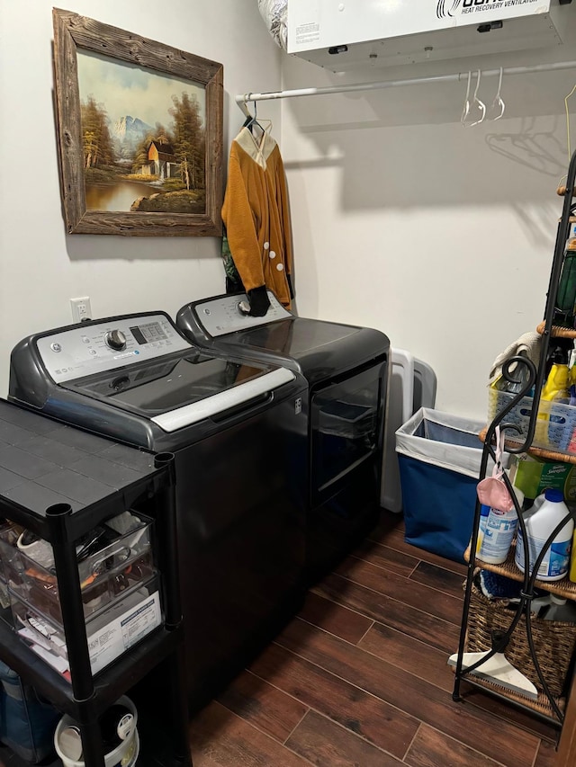 laundry area with wood finish floors, washing machine and dryer, and laundry area