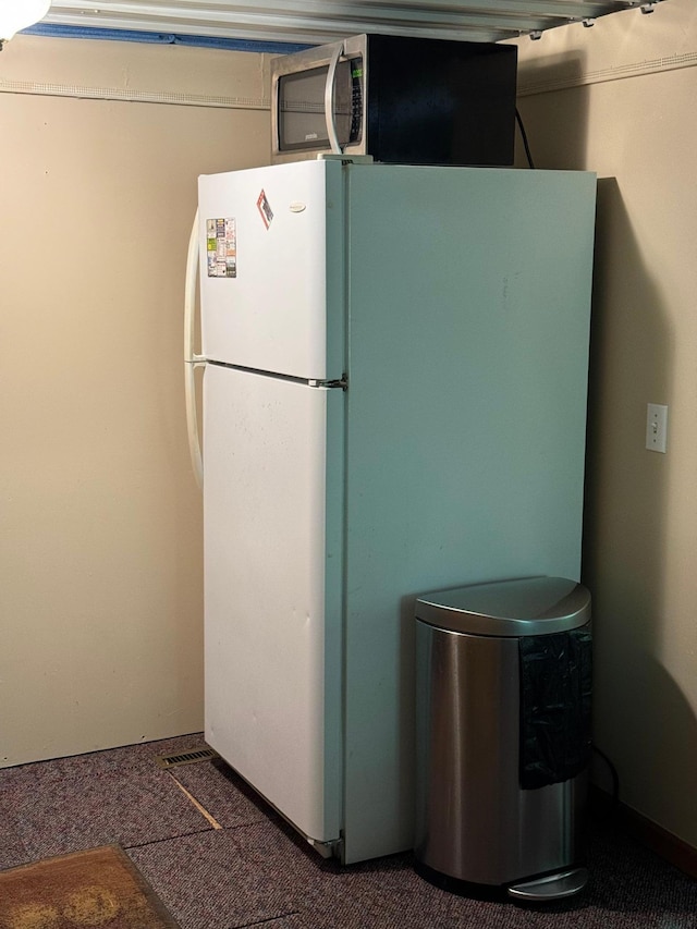 kitchen featuring carpet flooring and freestanding refrigerator