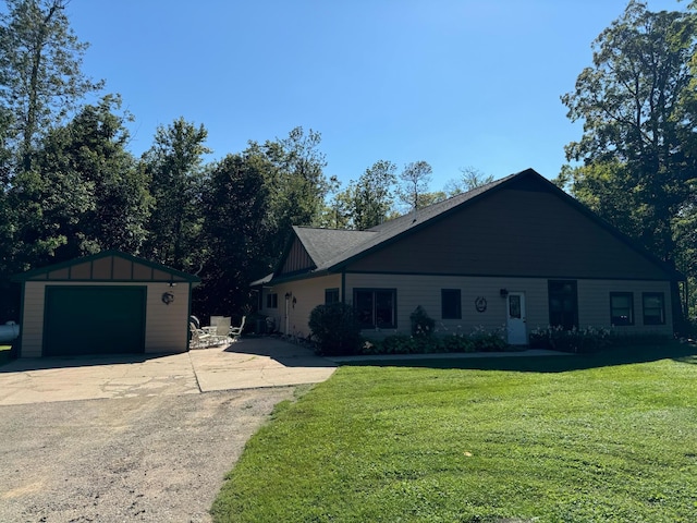 ranch-style home with an outbuilding, driveway, a front lawn, a detached garage, and board and batten siding