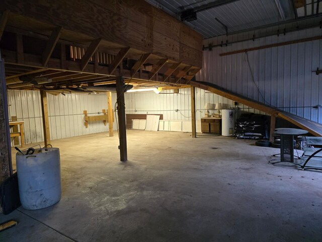 garage featuring metal wall and water heater