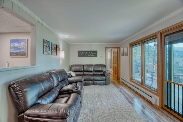 living area with wood finished floors, baseboard heating, and ornamental molding