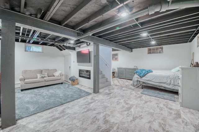 basement featuring stairway and a fireplace