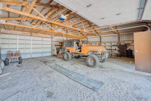 garage with a garage door opener and metal wall