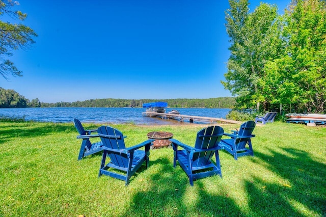 view of yard with a fire pit and a water view