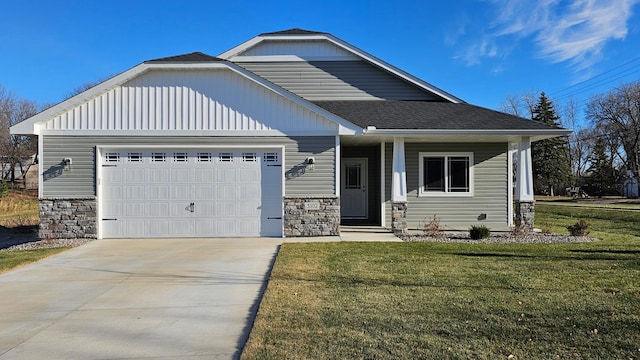 view of front of property featuring a garage, covered porch, and a front yard