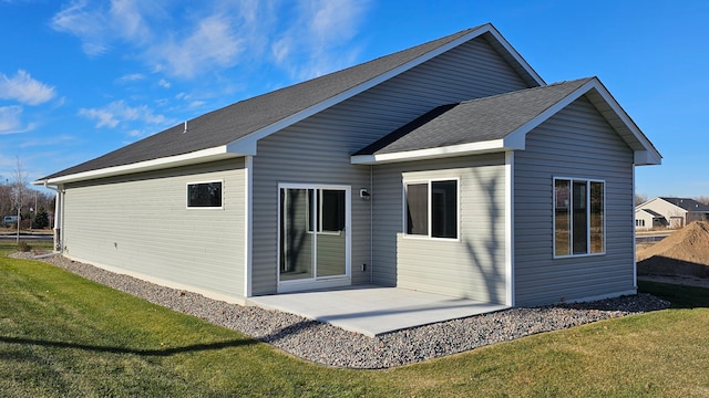 rear view of property with a patio area and a yard