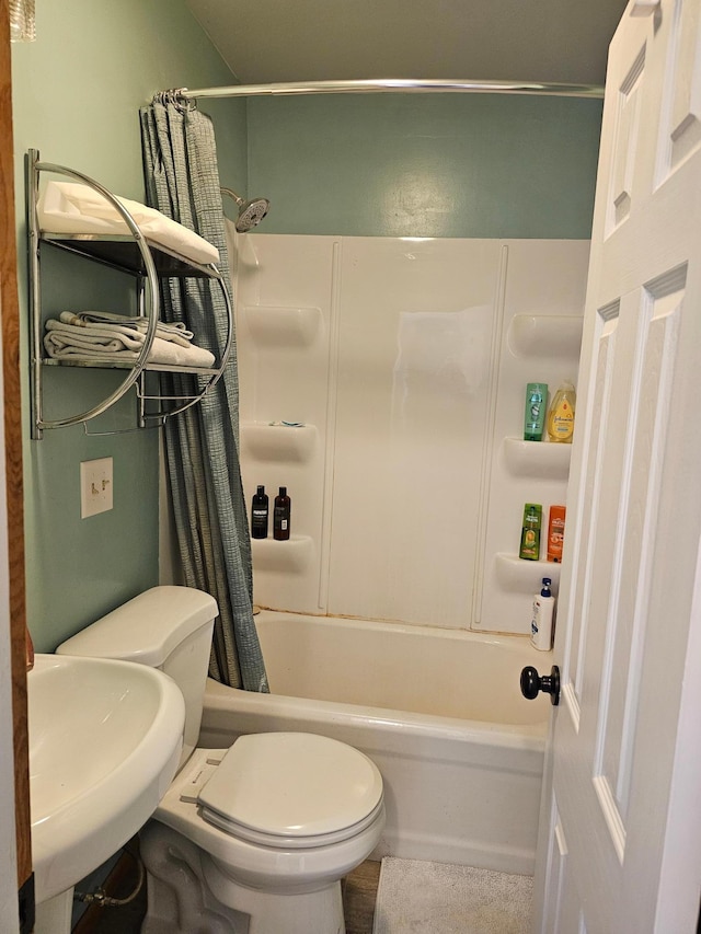 full bathroom featuring shower / bath combination with curtain, toilet, and sink