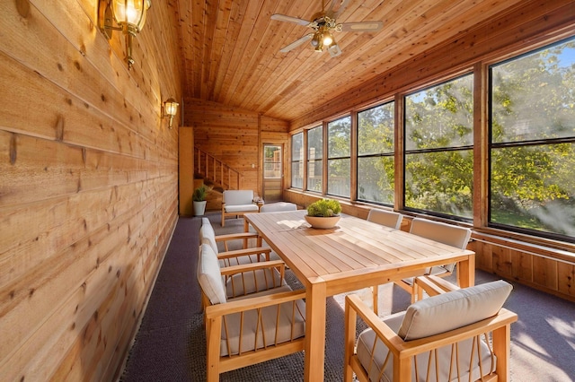 sunroom with a wealth of natural light, ceiling fan, wood ceiling, and lofted ceiling