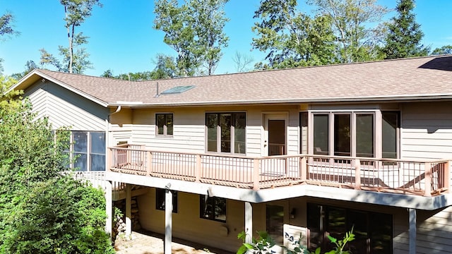 rear view of house featuring a deck