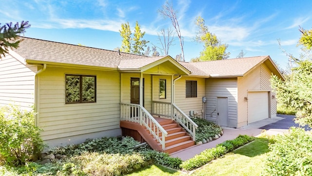 single story home featuring a garage and covered porch