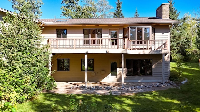 back of property featuring a lawn and a patio