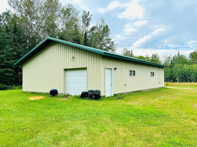 view of outbuilding featuring a garage and a yard