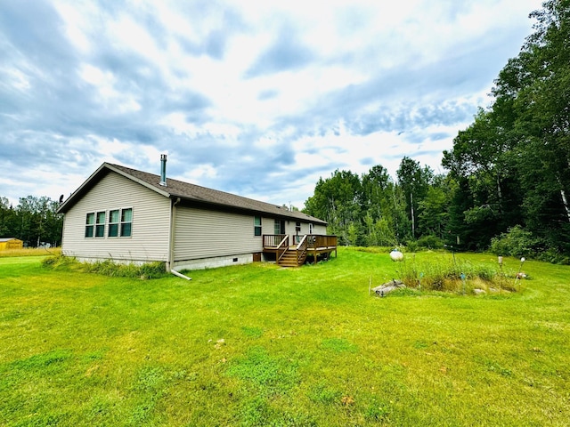 view of property exterior with a wooden deck and a yard