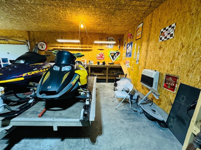 garage featuring a workshop area and heating unit