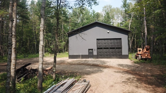 40900 Wall St, Manhattan Beach, MN 56442 - detached garage with dirt driveway and a wooded view