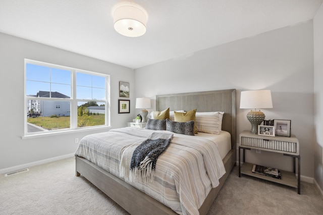 bedroom featuring light colored carpet