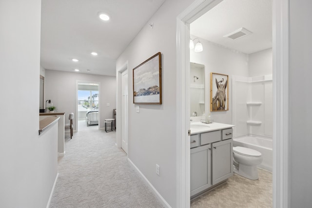 hall featuring sink and light colored carpet