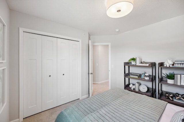 bedroom featuring a closet and light colored carpet