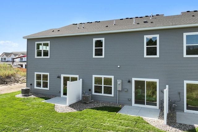 rear view of house featuring central AC, a patio area, and a yard