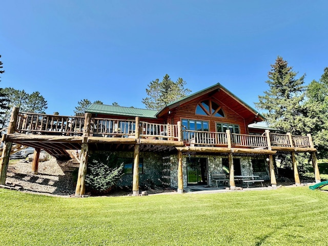 rear view of property with a deck and a lawn