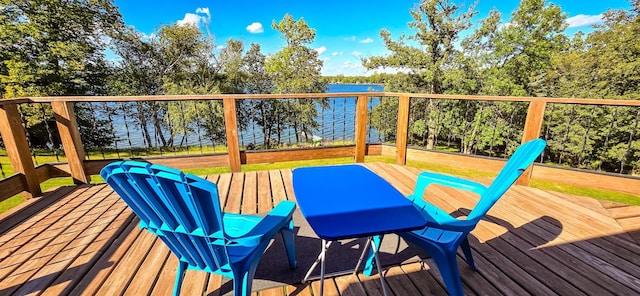 wooden terrace featuring a lawn and a water view