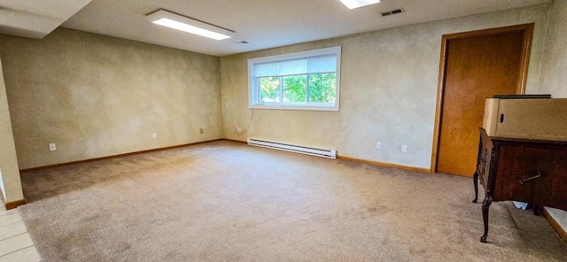 empty room with a textured ceiling, a baseboard radiator, and light colored carpet