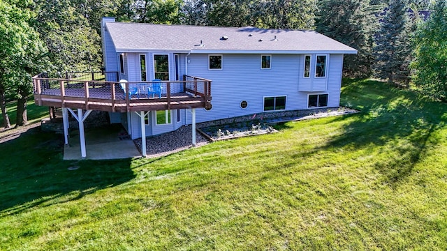 back of property with a wooden deck, a patio area, and a lawn