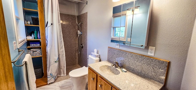 bathroom featuring vanity, curtained shower, and toilet