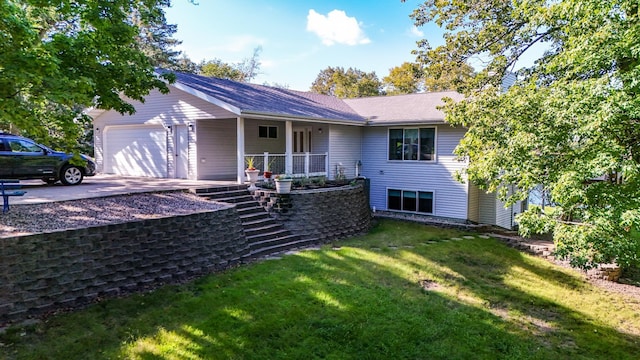 ranch-style home with a front yard, a garage, and a porch