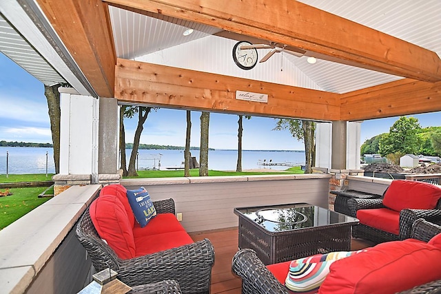 interior space with a water view, vaulted ceiling with beams, and a ceiling fan