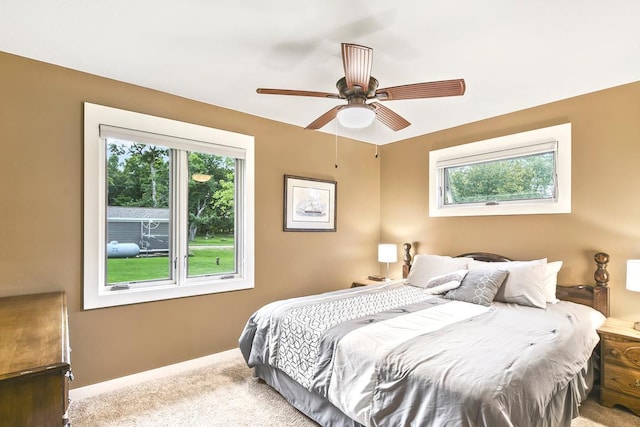 carpeted bedroom featuring a ceiling fan and baseboards