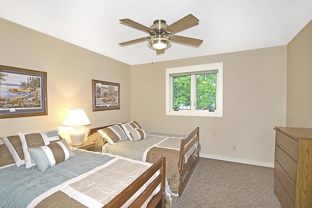 carpeted bedroom featuring a ceiling fan and baseboards