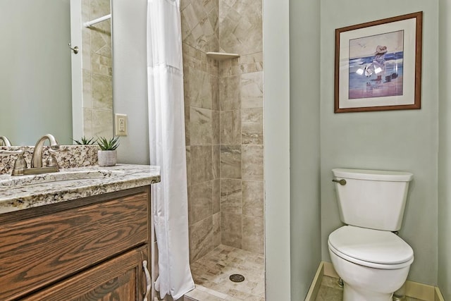 full bath with a stall shower, vanity, and toilet