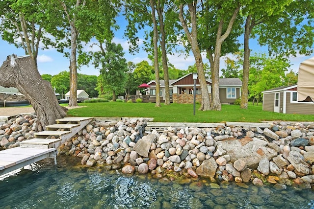 view of dock with a yard