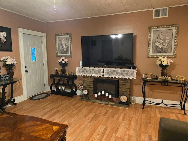 living room with light hardwood / wood-style flooring and crown molding