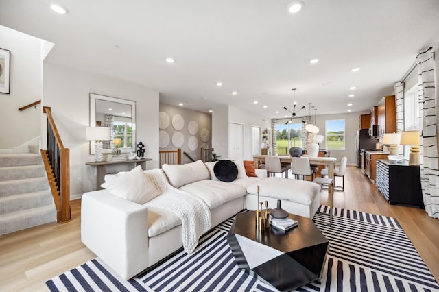 living room with a healthy amount of sunlight and light hardwood / wood-style floors