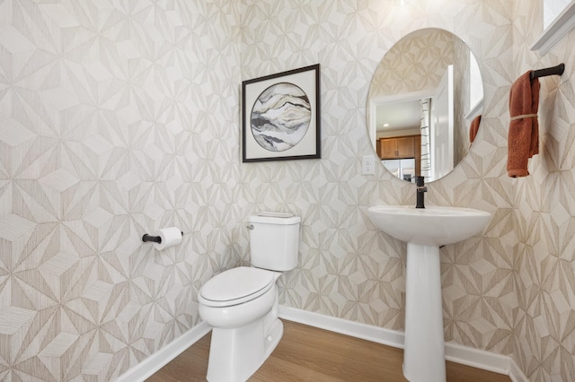 bathroom with tile walls, toilet, and hardwood / wood-style flooring