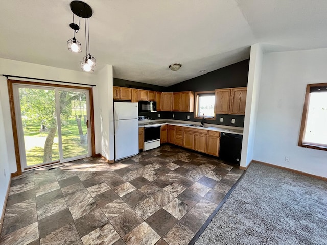 kitchen featuring pendant lighting, a wealth of natural light, sink, and black appliances