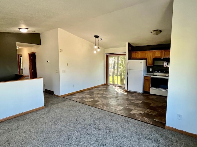 kitchen with white appliances, lofted ceiling, dark carpet, and decorative light fixtures