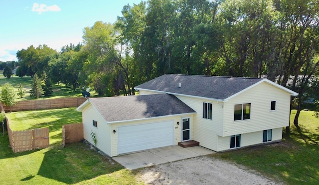 view of front of property with a front yard and a garage