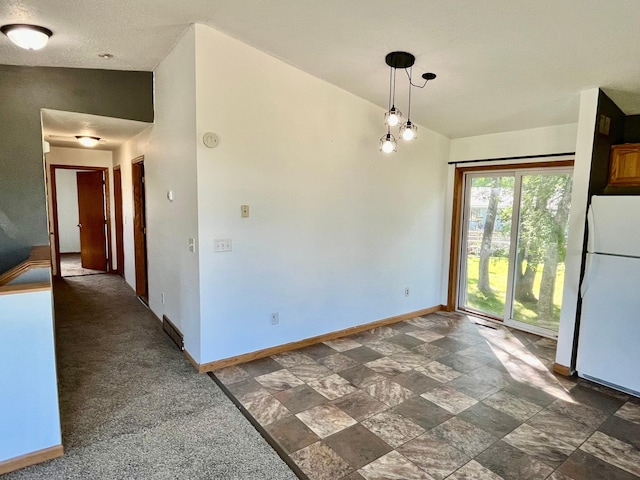 empty room with dark carpet and vaulted ceiling