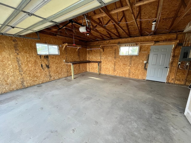 garage with a garage door opener and electric panel