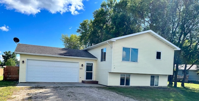 split level home featuring a garage and a front yard