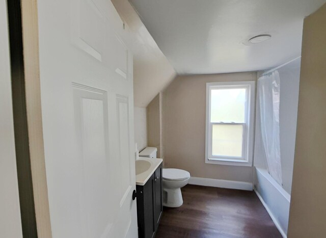 full bathroom featuring hardwood / wood-style floors, vanity, toilet, and shower / bathtub combination with curtain