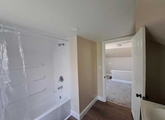 bathroom featuring wood-type flooring, vanity, and shower / bathtub combination