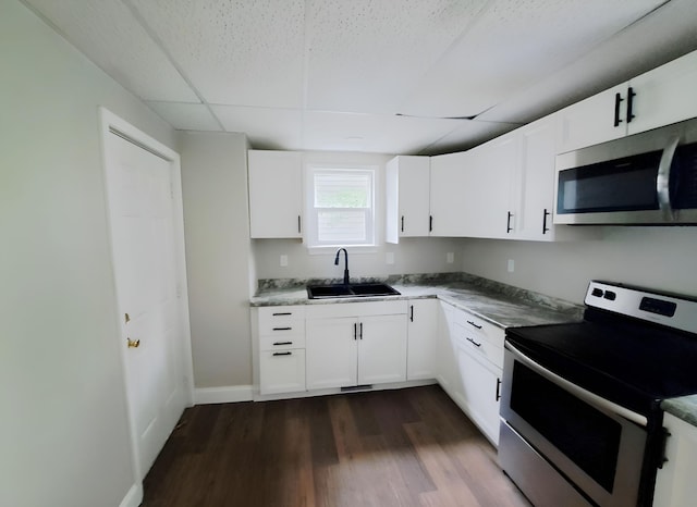 kitchen featuring dark hardwood / wood-style flooring, stainless steel appliances, white cabinets, and sink