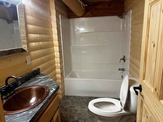 full bathroom featuring vanity, toilet, wooden walls, and shower / washtub combination