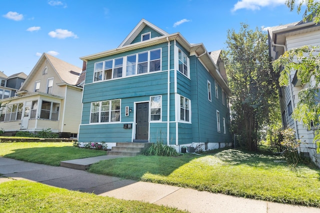 view of front of house featuring a front yard and cooling unit