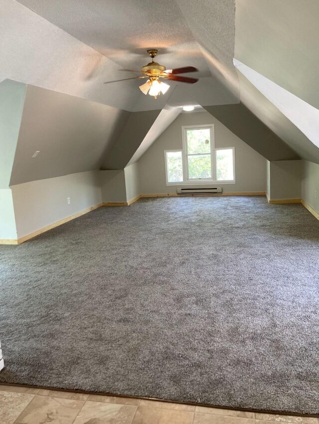 bonus room with light carpet, a baseboard heating unit, lofted ceiling, and ceiling fan