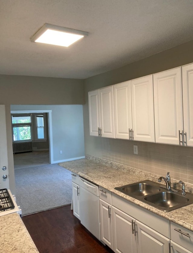 kitchen featuring decorative backsplash, white cabinetry, dishwasher, and sink